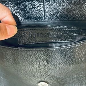 Leather black colored Nordstrom saddle
bag with shoulder strap. 
$70